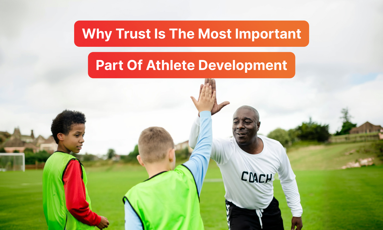 Photo titled "Why Trust Is The Most Important Part Of Athlete Development" showing a youth soccer coach in a white shirt giving a high five to a young player on a grass field, illustrating the coach-athlete relationship and trust in youth sports coaching