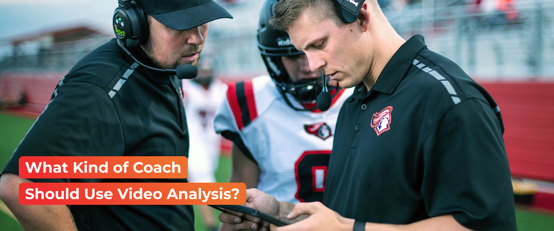 two football coaches wearing black t-shirts talking to a football player two football coaches wearing black t-shirts talking to a football player